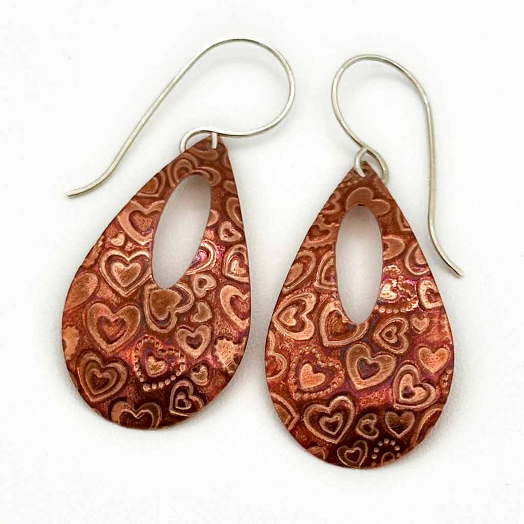 Handcrafted copper teardrop earrings with heart accents and Argentium sterling ear wires